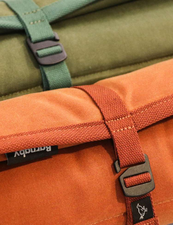 Close-up of a green and orange canvas dog mats showing aluminium clasp