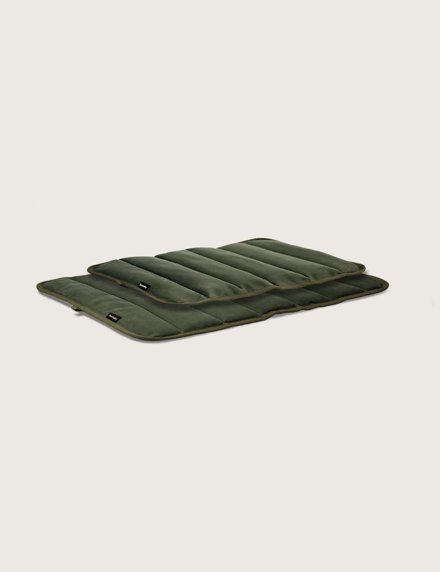 Green quilted mat on a light gray background